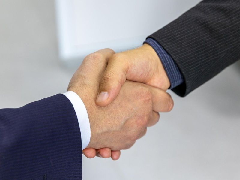Business handshake with B2B buyer